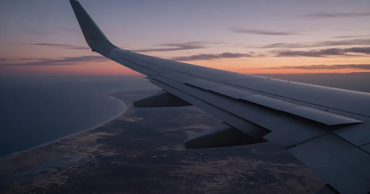 Repatriation Ticket in the UAE: Meaning and Rules Aircraft wing at dusk seen from a passenger window